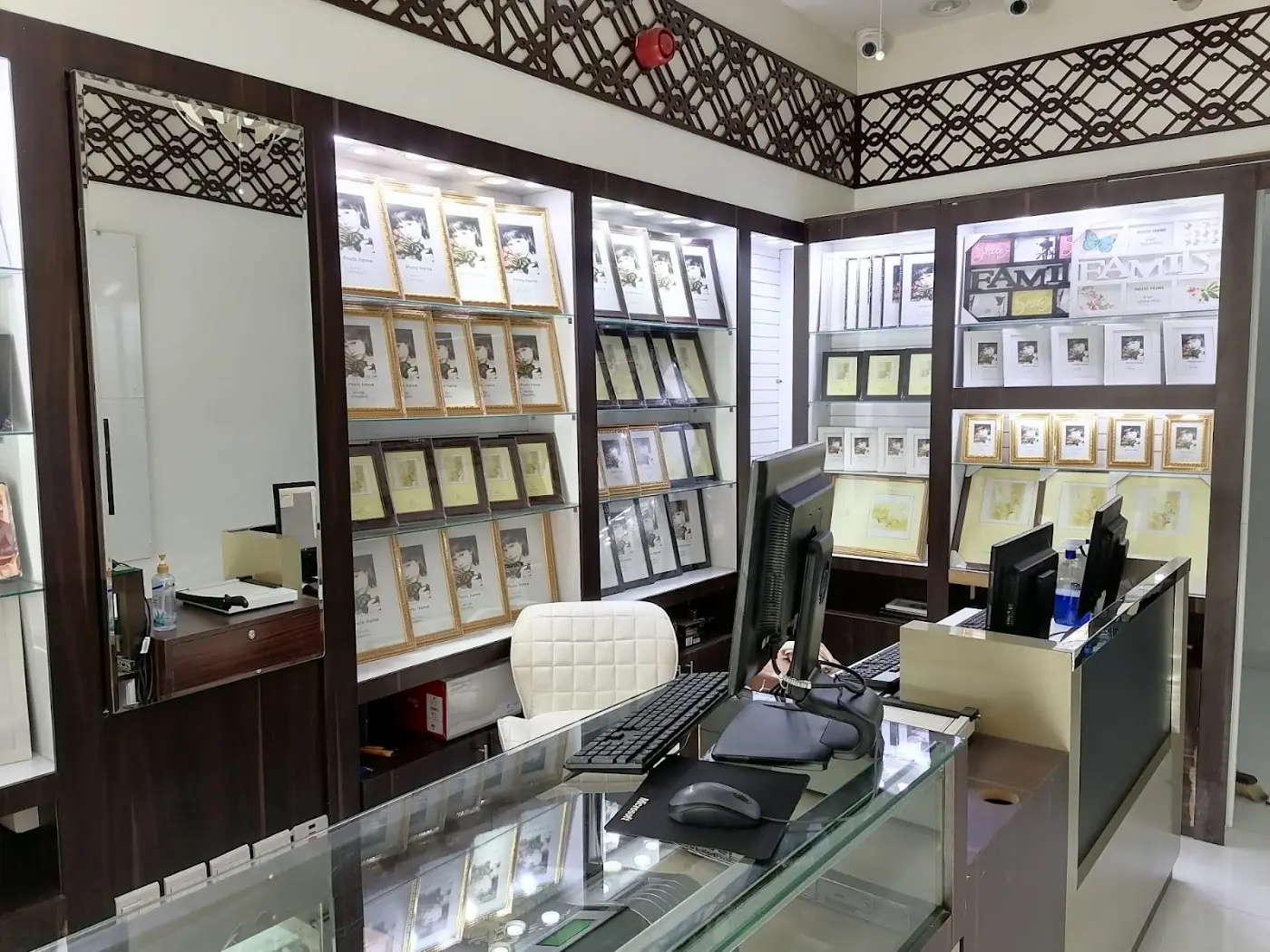 Inside Al Tarkiz Studio: the counter with frames and prints on display